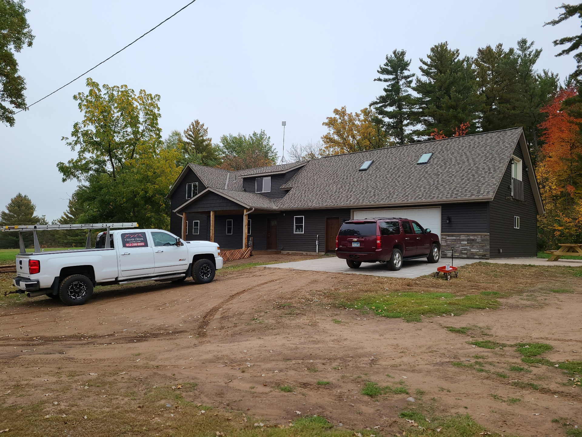 Dark siding home with Cedar Creek truck