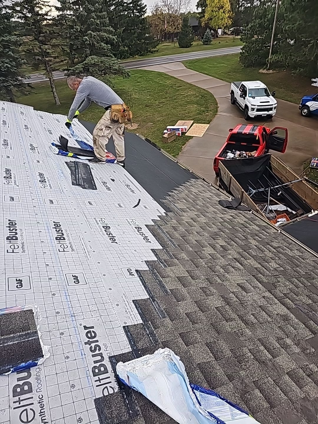 Roofing crew installing shingles